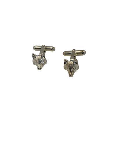 Pair of silver cufflinks on a light gray background